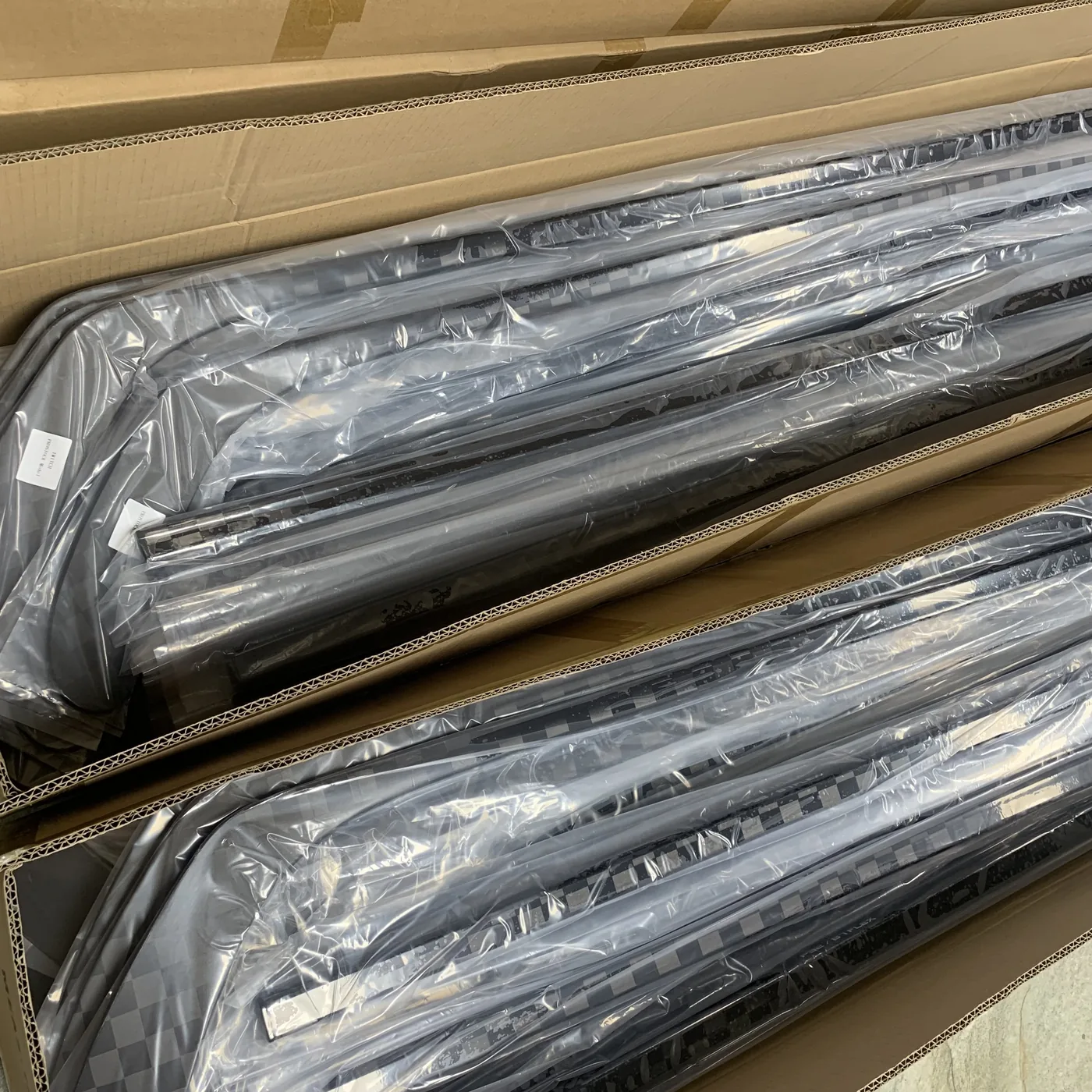 Hockey sticks individually protected inside open shipping cartons